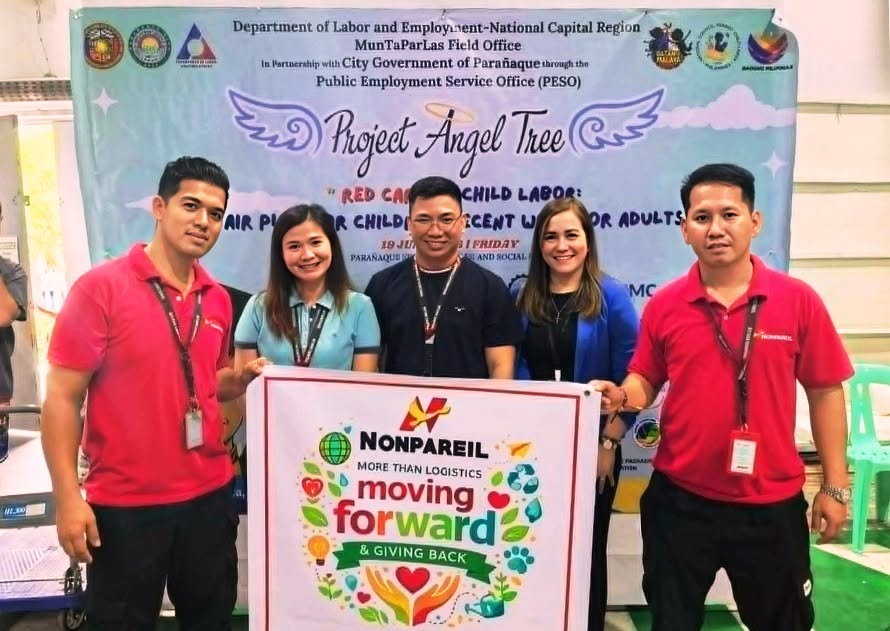 Nonpareil International team holding Moving Forward and Giving Back banner at Project Angel Tree event