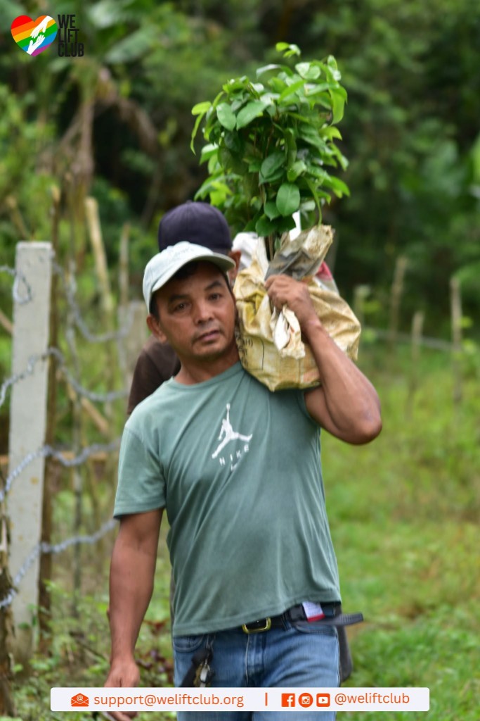 Team member transporting tree saplings in a sack for the planting activity